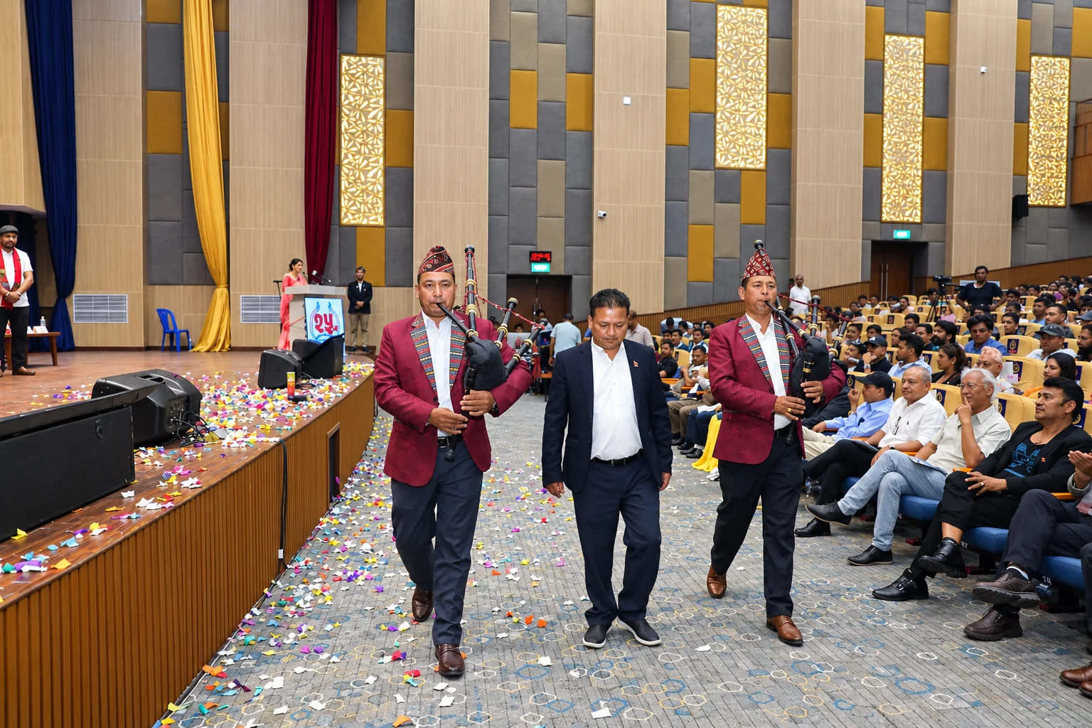 Event photograph · bagpipers · auditorium